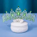 Elegant silver crown with vibrant green crystals on a white ceramic jewelry box - Silver and All Green