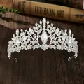 Vintage silver tiara with clear crystals and teardrop gems on a wooden surface - Style 13 Silver White