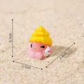 Miniature pink octopus figurine with yellow shell hat measuring 2.4x2.1x2.1 cm on sand - No.11-Pink Octopus