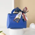 Elegant blue leather wedding favor bag with silk scarf bow for premium candy packaging. - Bright Blue