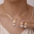 Detail of elegant gold flat snake chain necklace and matching heart pearl earrings set - Heart Pearl Style - Gold