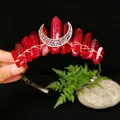 Detailed view of handmade red crystal tiara with filigree silver moon ornament - Dark Red