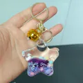 Creative star-shaped acrylic liquid quicksand keychain with purple glitter and gold bell - Bell Style / Purple