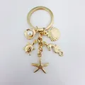 Elegante portachiavi dorato a tema oceano con stella marina, tartaruga, cavalluccio marino - Ciondoli Oceano Dorati (Q1541)