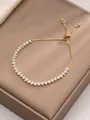 Detail of gold bolo bracelet featuring marquise-cut zircons and adjustable slider clasp - White