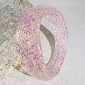 Detailed close-up of pink translucent resin bangle with shimmering iridescent flakes - Pink