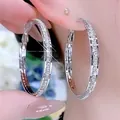 Detailed close-up view of silver-toned hoop earrings adorned with sparkling zircon stones - Full Pave Zirconia Luxury Hoop (E2597 Silver) / 925 Silver Needle / Silver