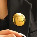 Elegant luxury gold spiral stainless steel brooch pinned on a black women's blazer - Round Spiral Style (10472)