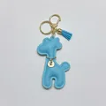 Detail of cute light blue leather giraffe keychain with gold hardware and tassel - With Keychain Tassel / Sky Blue