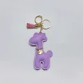 Detail of purple PU leather giraffe keychain with pink tassel and gold charm - With Keychain Tassel / Purple