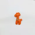 Close-up of an orange leather giraffe charm with a gold chain and pendant - Giraffe Charm / Orange