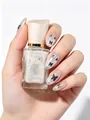 Shimmering white micro-gel nail polish bottle shown with butterfly nail art design - 33 Fluttering Butterfly