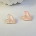 Close-up view of translucent pink candy-colored heart-shaped stud earrings for women - Candy Pink (32439-ear-pink-EP)