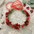 Detailed view of bohemian red flower crown headband with green leaves and red ribbon - Red