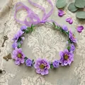 Close-up of bohemian purple floral crown with delicate fabric petals and green leaves - Purple