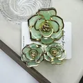 Green and gold floral hair clip set with camellia design on product card - Green Rose Jelly Set With Gold-edged Clasp (includes Card)