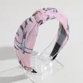 Elegant pink knotted wide headband featuring an artistic bird and floral print pattern - Pink Bird Print