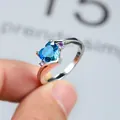 Elegant silver ring featuring a heart-shaped blue zircon and purple side stones - US 7 / Silver Tone Blue Green Zirconia