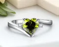Elegant silver-colored fashion ring featuring a vibrant heart-shaped green zircon gemstone - US 7 / Silver Tone Olive Green Zirconia