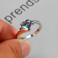 Elegant silver-tone ring featuring a heart-shaped rainbow zircon and side gems - US 7 / Silver Multicolor Zirconia