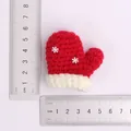 Handmade red crochet mitten ornament with snowflake detail and ruler measurement - Christmas Snowflake Gloves