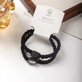 Schwarze hochelastische Haargummis mit ovalem Strass-Detail auf einer weißen Karte - Ovaler Strass-Stil / 2er Pack / Schwarz