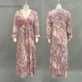 Front and back view of bohemian paisley print maxi dress with ruffled cuffs on mannequin - S / As Shown