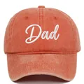 Detail shot of an orange washed cotton baseball cap with white DAD script embroidery - Orange Dad