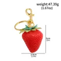 Realistic red strawberry keychain bag pendant showing dimensions and 47.39g weight - Red Realistic Strawberry Pendant (k00978-02)