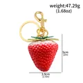 Realistic 3D strawberry fruit keychain for backpack featuring dimensions and weight info - Red and White Gradient Strawberry Pendant (k00978-03)