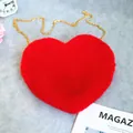 Vibrant red heart-shaped plush crossbody bag featuring a stylish gold chain strap - Red
