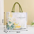 Large canvas tote bag featuring yellow chamomile floral patterns and green handles - Daisy Print Pattern / L