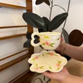 Detail of ceramic coffee cup with heart handle and floral petal saucer set - Pink Petals And Green Leaves Cloud-shaped Cup 300ml + Saucer 17cm