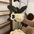Detail of hand-painted floral ceramic coffee mug with a unique heart-shaped handle - Pink Petals Green Leaves Cloud Design 300ml Per Cup