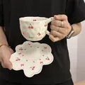 Creamy white irregular ceramic coffee cup and floral saucer with cherry bow design - Cherry Bow Cloud Cup 300ml + Saucer 17cm