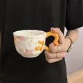 Handmade ceramic coffee cup with orange wavy handle and colorful floral patterns - Orange Flower Cloud Single Cup 300ml