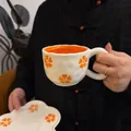 Ceramic coffee cup and saucer set with irregular wavy edges and orange floral patterns - Orange Petal Cloud Single Cup 300ml