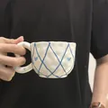 Handmade ceramic coffee mug with blue diamond pattern and pink bow accents - Embossed Blue Mesh Cloud Single Cup 300ml