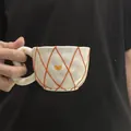 Handcrafted irregular ceramic coffee mug with orange check pattern and yellow heart - Embossed Orange Mesh Cloud-shaped Single Cup 300ml