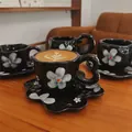 Handmade black floral ceramic coffee cup with wave handle and flower-shaped saucer - Black Background With White Petals Cloud-shaped Cup (300ml) + Saucer (17cm)