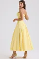 Detail of light yellow corset dress with structured boning and pleated maxi skirt - XS / Dresses / Yellow