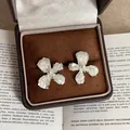 Detail of shell flower stud earrings with pearl center in a vintage velvet box - Four-Petal Flower Style / Silver