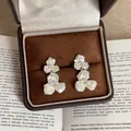 Close-up of shell flower earrings with pearl finish in a premium jewelry box - Double Layer Flower Style / Silver