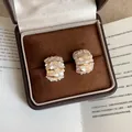 Elegant C-shaped golden earrings with crushed shell inlay in a brown velvet gift box - C Shape Gold Crushed Stone Style