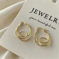 Elegant gold irregular geometric hoop earrings for women, minimalist luxury style - Spiral Geometric Style / Gold