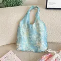 Detailed macro view of light blue floral lace tote bag with delicate sheer textured fabric - Misty Blue Floral / Vest Style