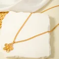 Close-up view of a vintage gold flower pendant necklace on a decorative stone base - Gold Brushed Flower Pendant Necklace (29956-nek-G-4)