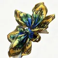 Vibrant yellow paisley pattern bow hair claw clip for stylish summer vacation looks - Ginger And Blue Paisley