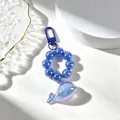 Detailed view of a translucent purple whale charm on a sparkling blue beaded keychain - Sapphire Blue