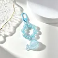Macro detail of a translucent blue whale pendant with a sparkly beaded keychain ring - Sky Blue